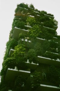 A high rise building covered in plants