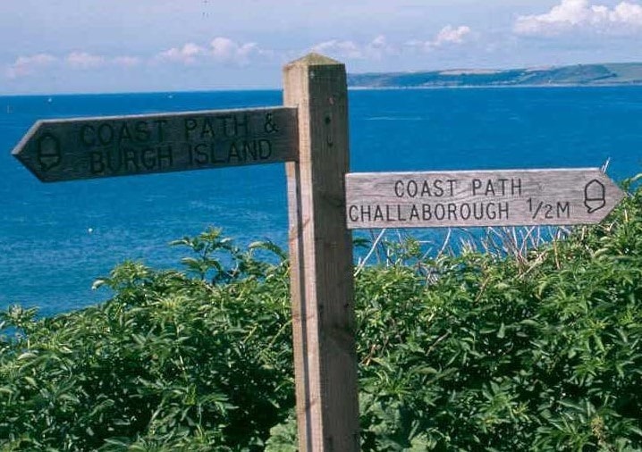 wooden signpost on cliff path