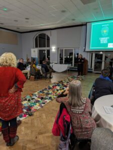 View of the colourful mossy carpet made out of wool, lying across the awards room floor. Photo credits kate Hind, DCC.